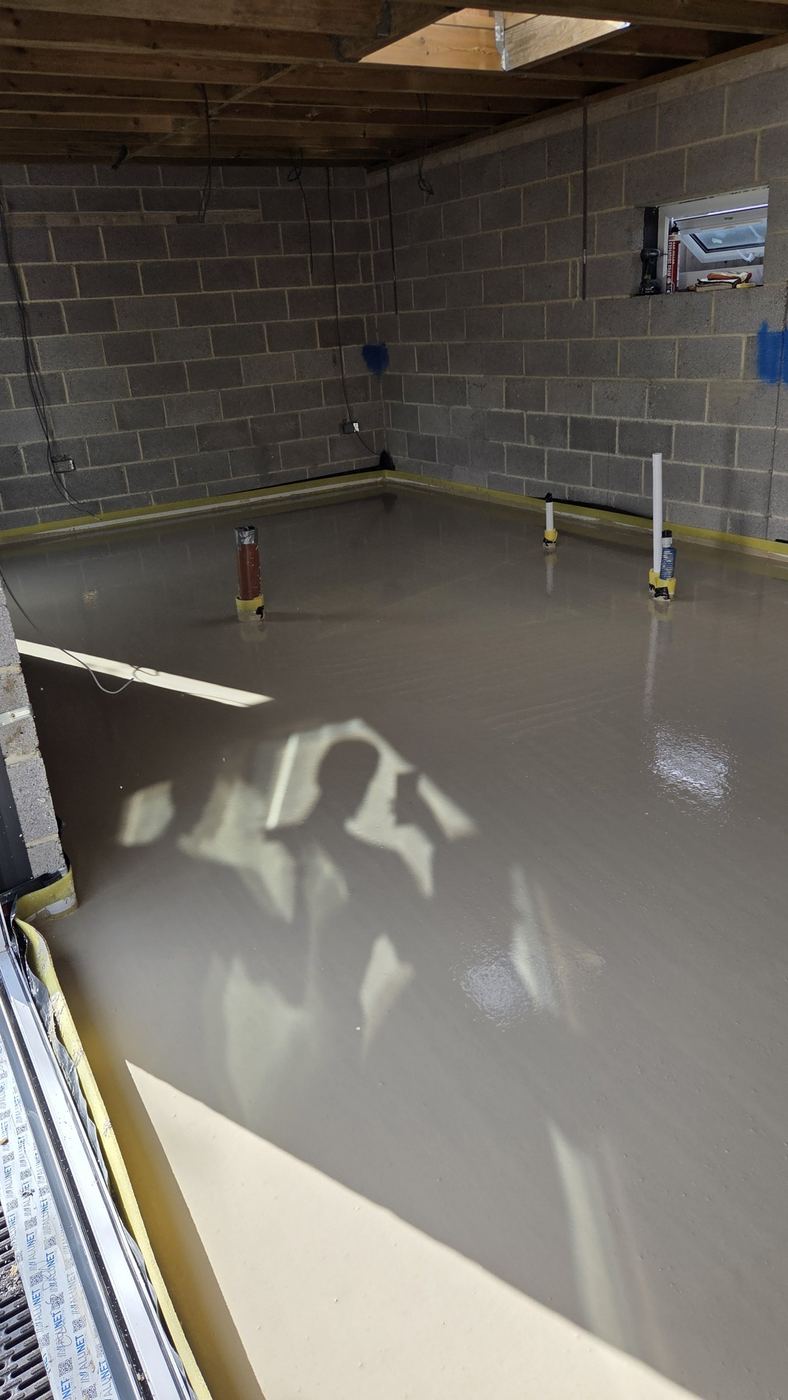 Liquid screed poured over underfloor heating